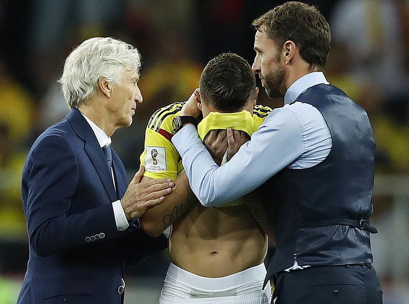 Colombia head coach Jose Pekerman, left, and England head coach Gareth Southgate, right, comfort Colombia’s Mateus Uribe after the round of 16 match between Colombia and England at the 2018 soccer World Cup in the Spartak Stadium, in Moscow, Russia, Tuesd